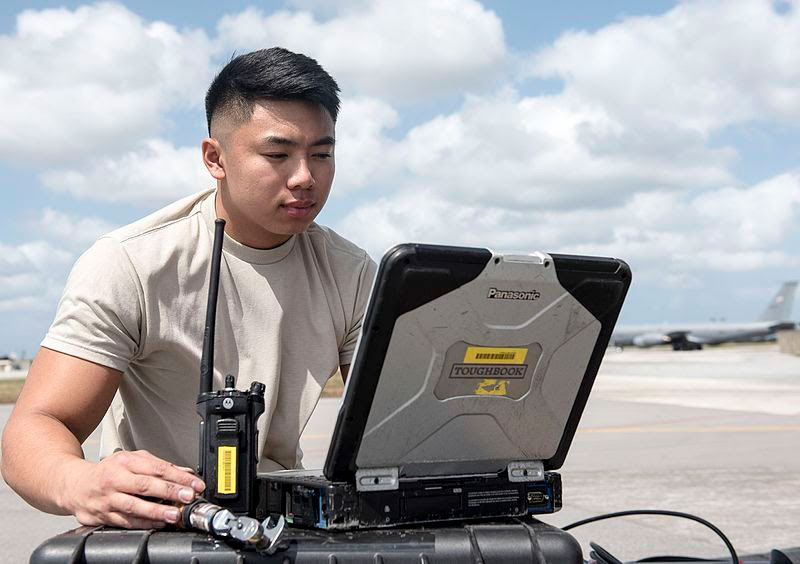 aviation technician working with a toughbook in the field