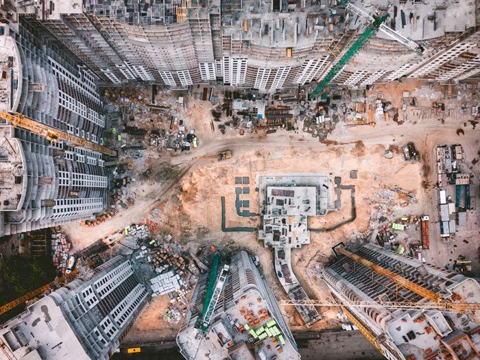 An overhead view of a large construction site in a big city