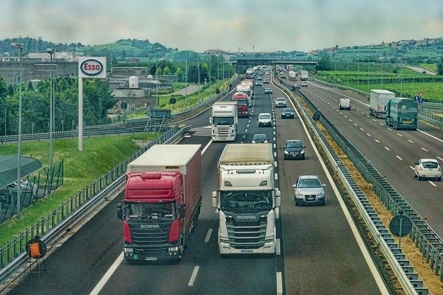 Semi-trucks driving on a busy highway