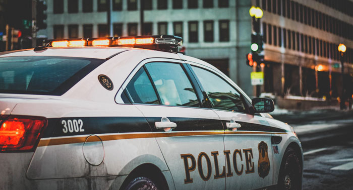 A police cruiser sitting on the street of a large city