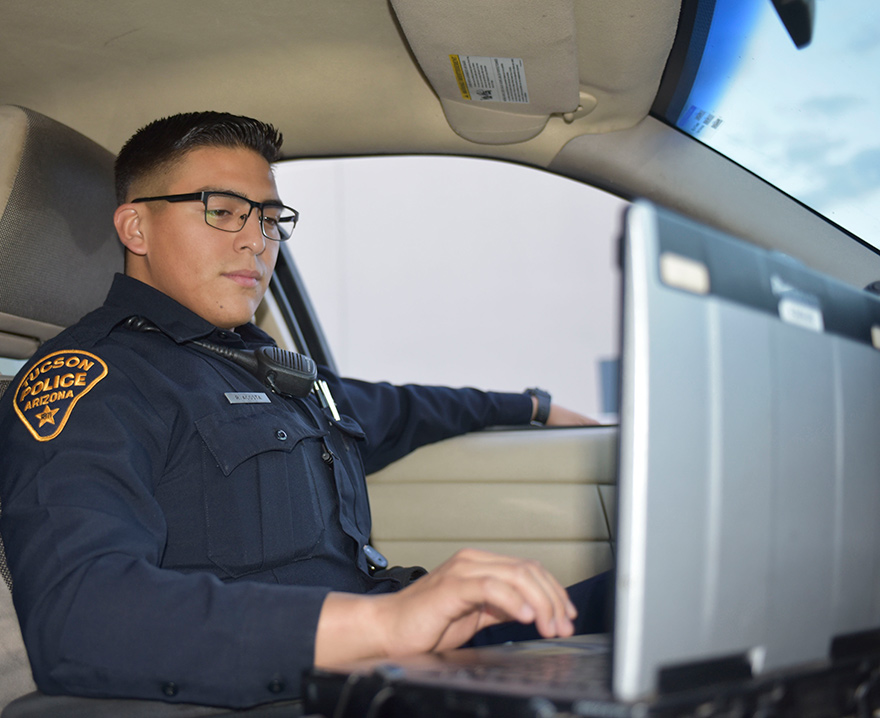 police officer using a military laptop