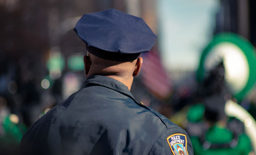 Uniformed police officer from behind 