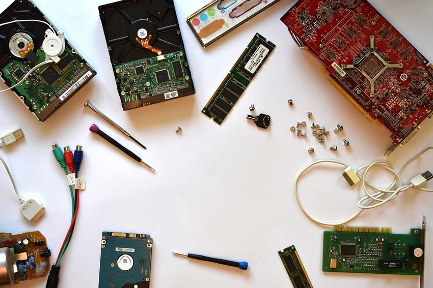 Computer hardware spread out over a white desk